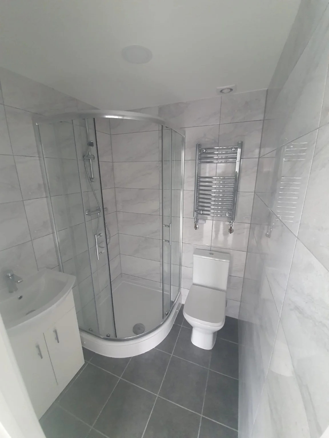 Completed shower room with basin and tiled finishes