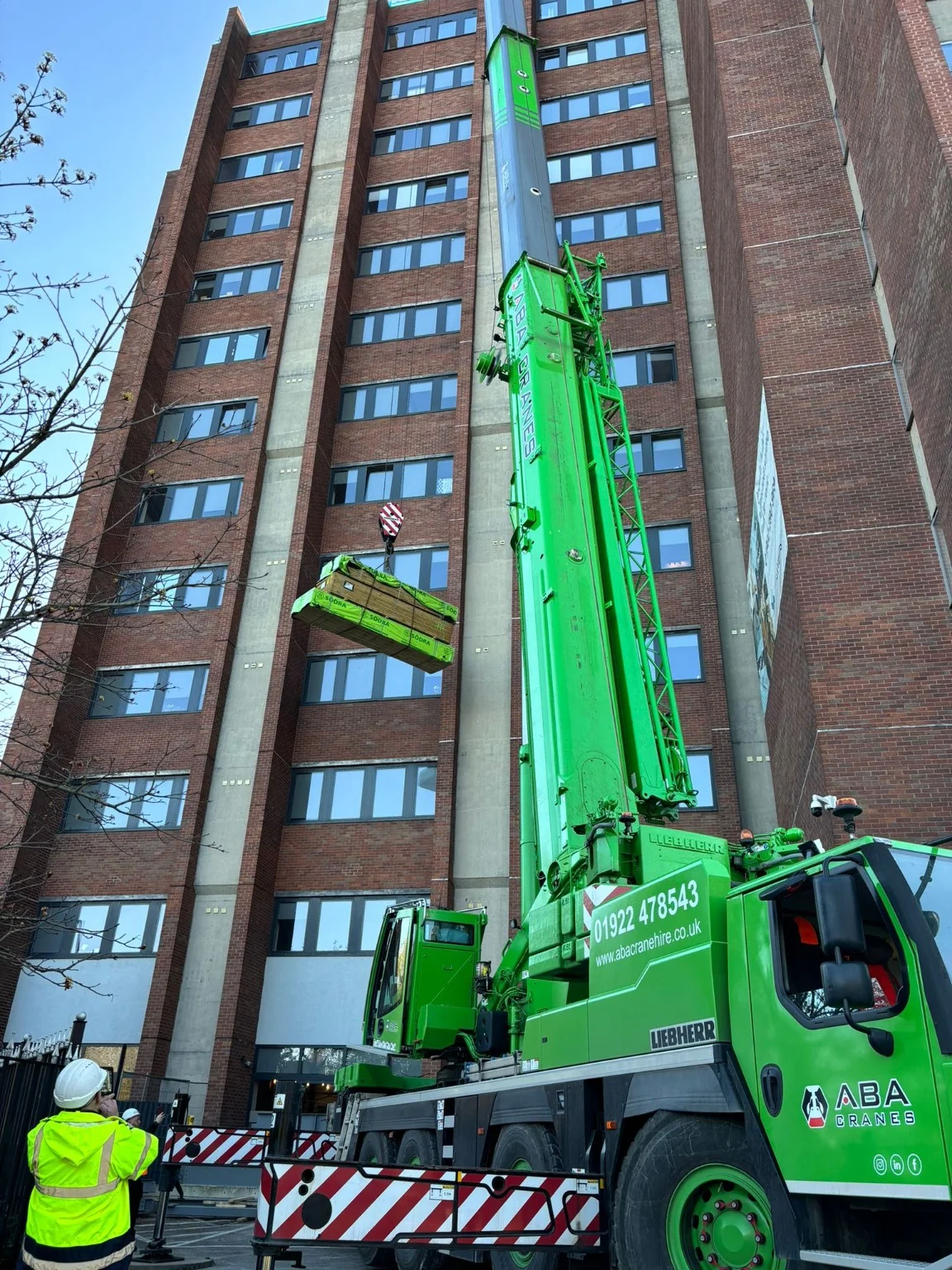 Mobile crane lifting materials to the upper floors